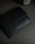 Black ED Classic wallet holding cards, folded Singapore notes