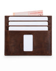 Rear of brown Ed Classic crazy horse leather slim wallet with white cards and a Singapore note