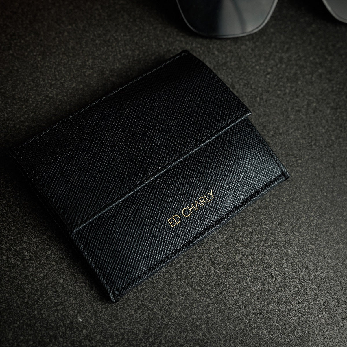 Black ED Classic wallet holding cards, folded Singapore notes