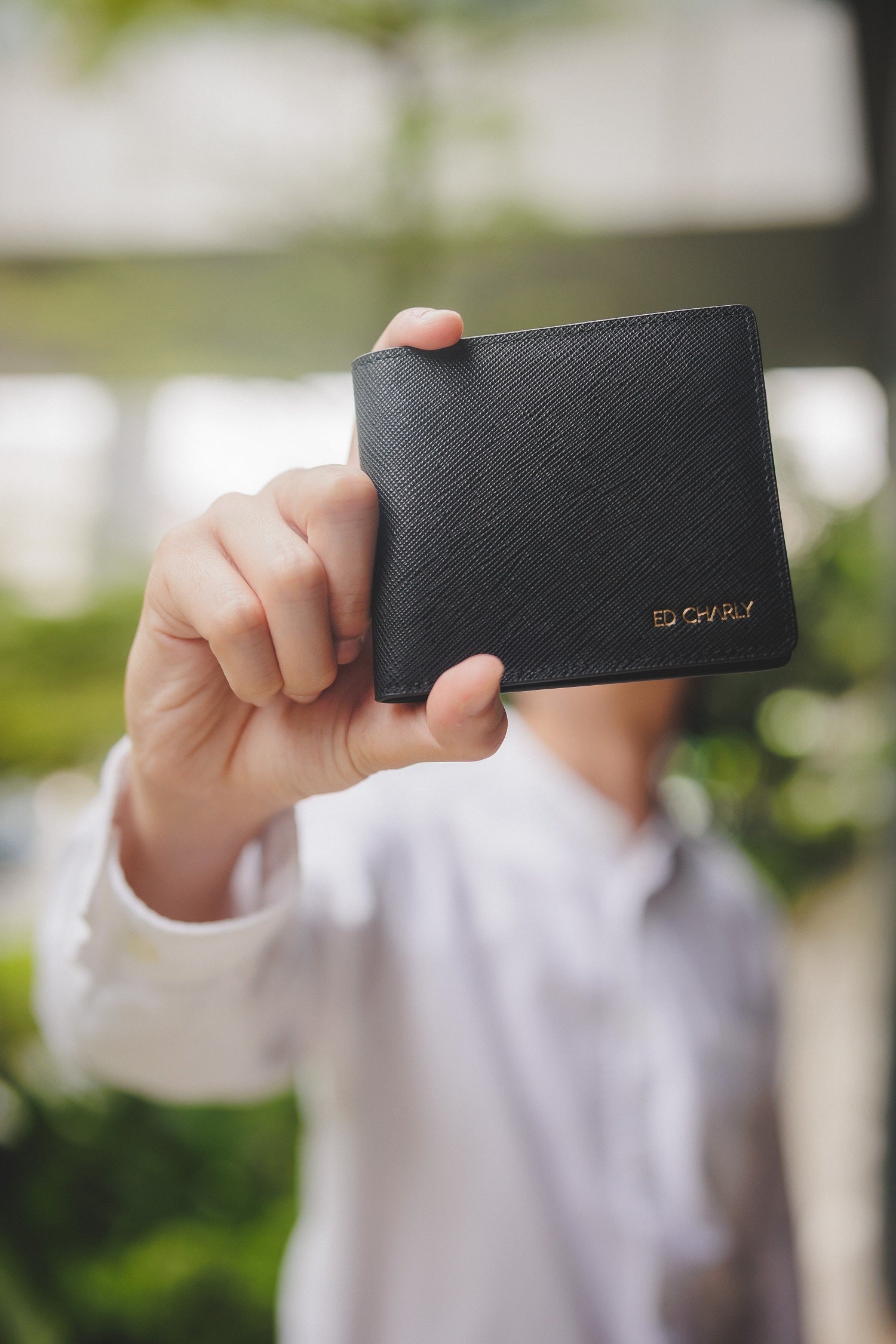 black Ed Sleek Bifold Saffiano wallet showing its compact shape and logo
