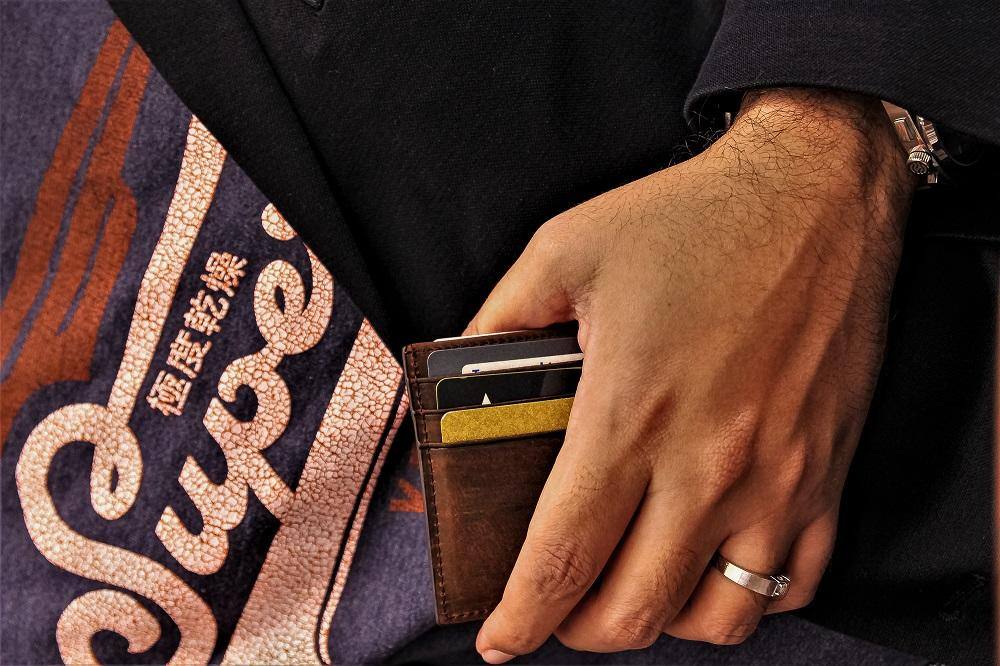 holding onto a slim card wallet